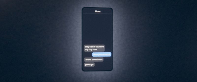A phone on the wall showing a text conversation that ends in goodbye.