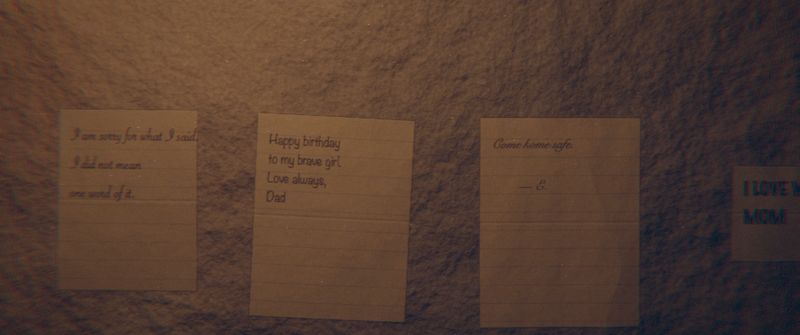 Handwritten notes pinned to the cave wall: an apology, a birthday card from Dad.